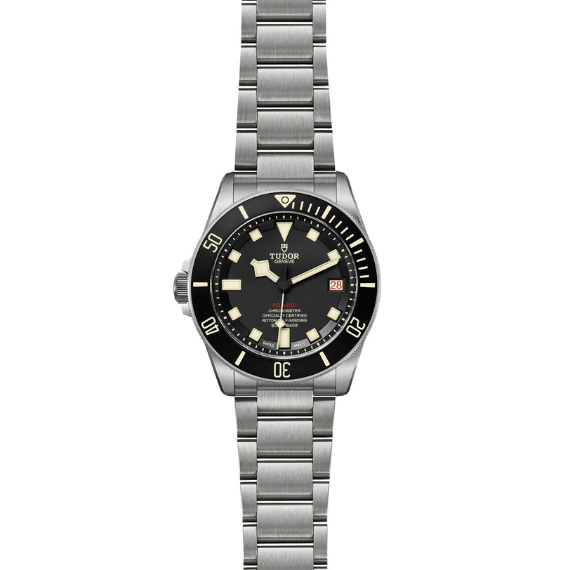 The TUDOR Pelagos LHD is a diver’s watch with a stainless steel case, black bezel, black dial with luminescent markers, date at 3 o’clock, and a sturdy metal bracelet.