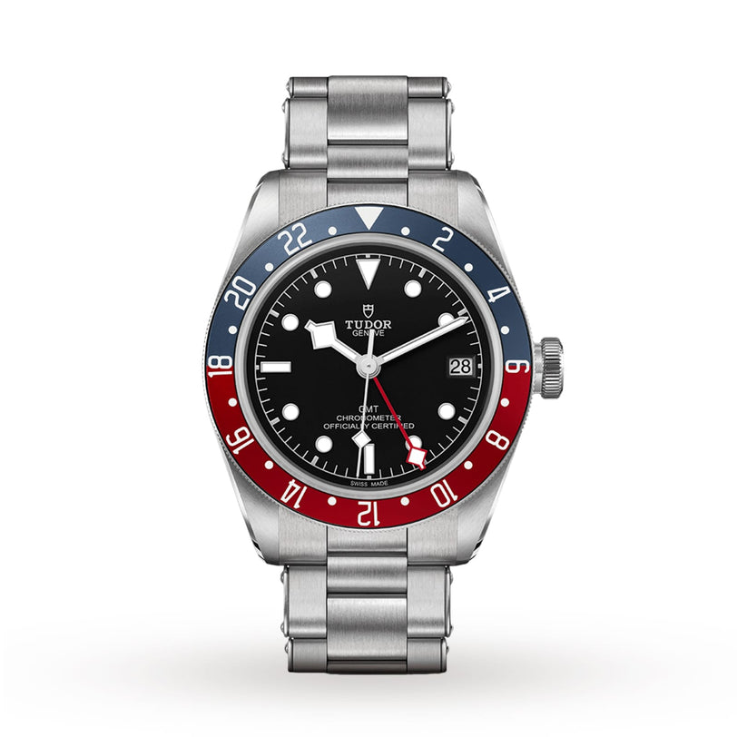 The TUDOR Black Bay GMT wristwatch features a stainless steel band, black dial, date window, and a distinctive red and blue 24-hour bezel inspired by classic diving watches.