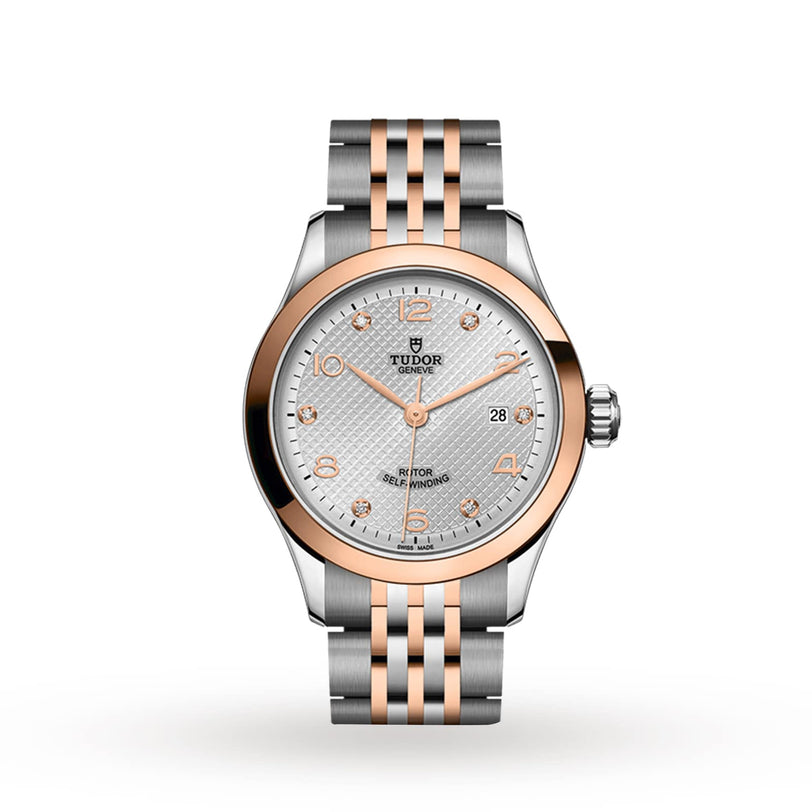 The TUDOR 1926 is a two-tone watch with a silver and rose gold bracelet, rose gold bezel, white textured dial, date display, and diamond hour markers.