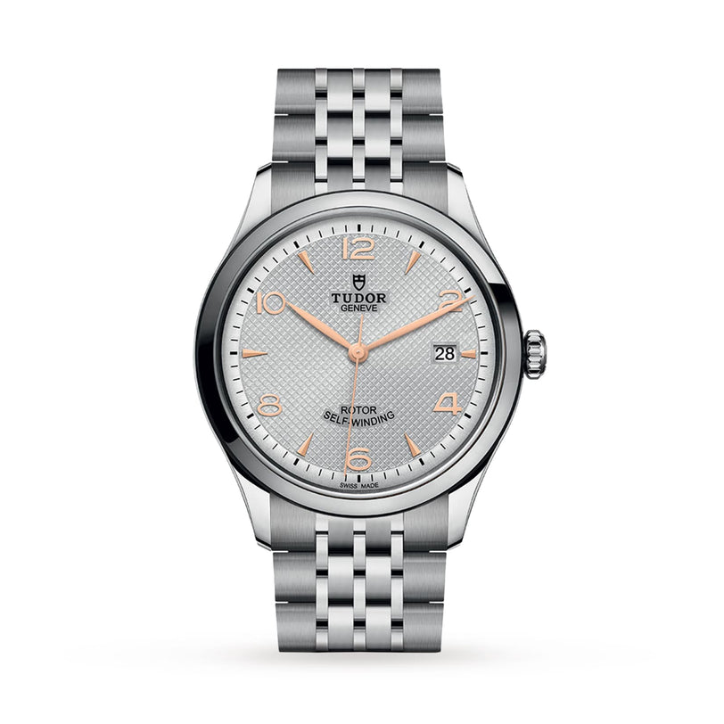 The TUDOR 1926 is a classic stainless steel watch with a silver textured dial, gold-tone markers and hands, a date window at 3 oclock, and a stylish metal link bracelet—a refined nod to fine mechanical timepieces.