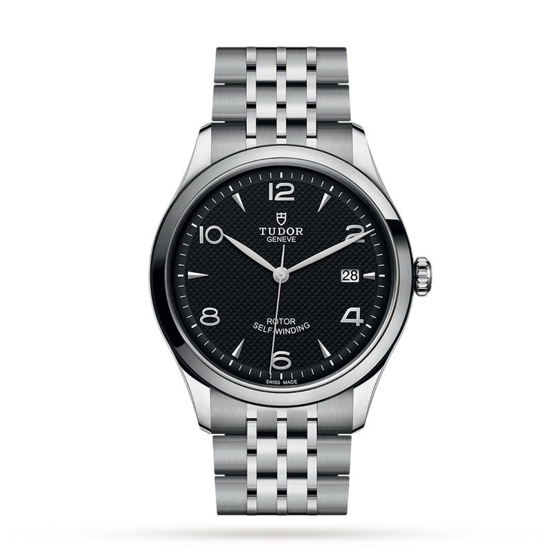 A TUDOR 1926 stainless steel wristwatch featuring a black textured dial, silver hour markers, date at 3 o’clock, and a metal bracelet is displayed on a white background, showcasing the refined style of TUDOR.