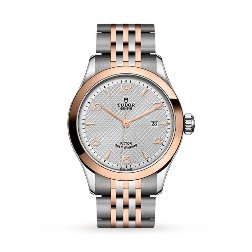 The TUDOR 1926 is a classic, elegant wristwatch with a two-tone silver and rose gold bracelet, silver textured dial, gold hour markers, and a date display at 3 o’clock—ideal for mechanical watch enthusiasts.