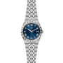The TUDOR Royal is a stainless steel wristwatch featuring a blue dial, Roman numerals, date at 3 o’clock, and a metal bracelet—ideal for enthusiasts of automatic sport-chic timepieces.
