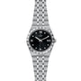 The TUDOR Royal is a stainless steel and gold wristwatch featuring a black dial, silver hour markers, date at 3 o’clock, and metal bracelet—an automatic sport-chic watch combining style and timeless elegance.