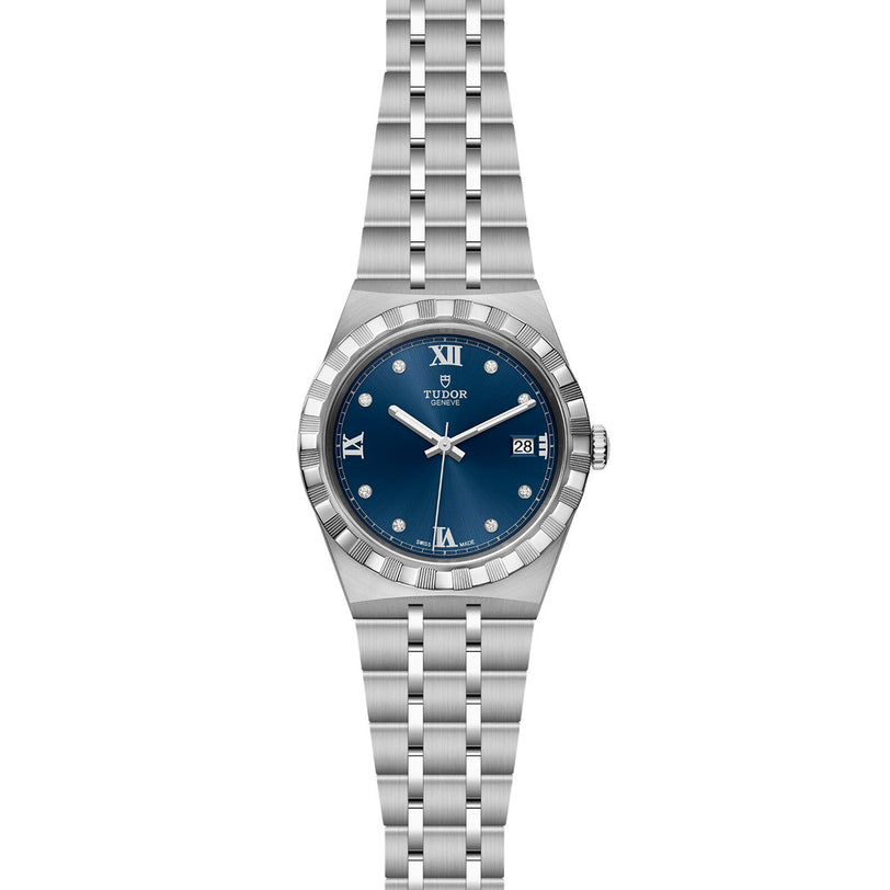 The TUDOR Royal is a silver automatic sport-chic watch featuring a blue dial with Roman numerals, diamond hour markers, date at 3 o’clock, and a stainless steel integrated bracelet.