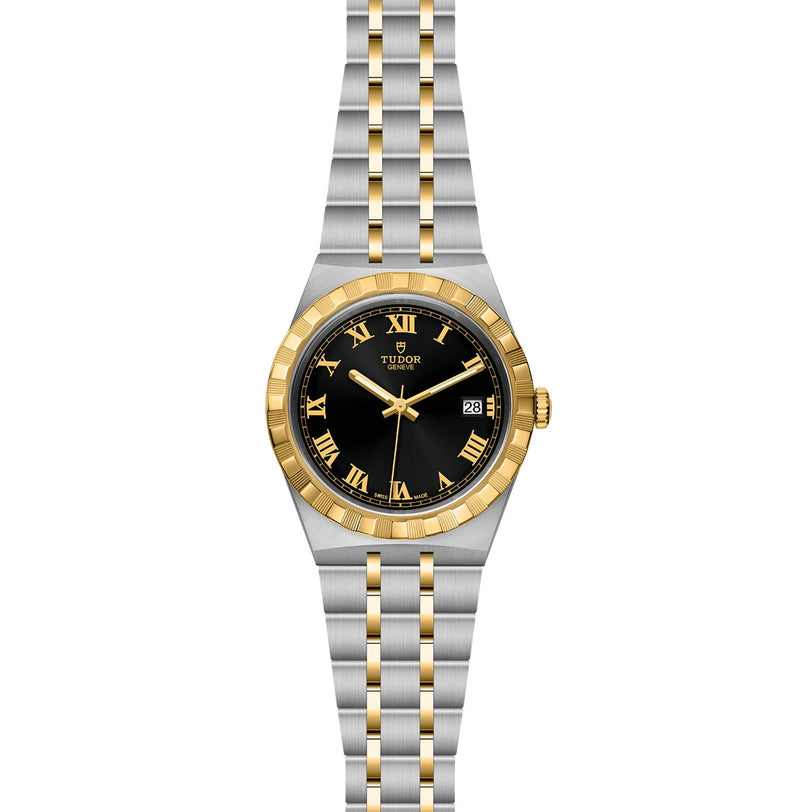 The TUDOR Royal is a two-tone automatic watch featuring a black dial, gold Roman numerals, gold bezel, and an integrated stainless steel and gold bracelet. It displays the date at 3 o’clock.