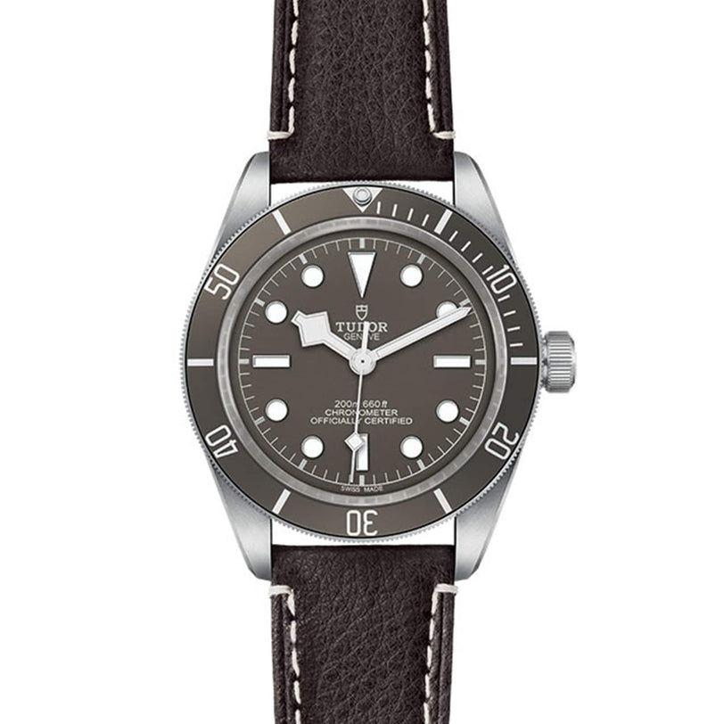 A TUDOR Black Bay 58 925 wristwatch featuring a 39mm case, black bezel, black dial with silver hour markers, and a black leather strap with white stitching.