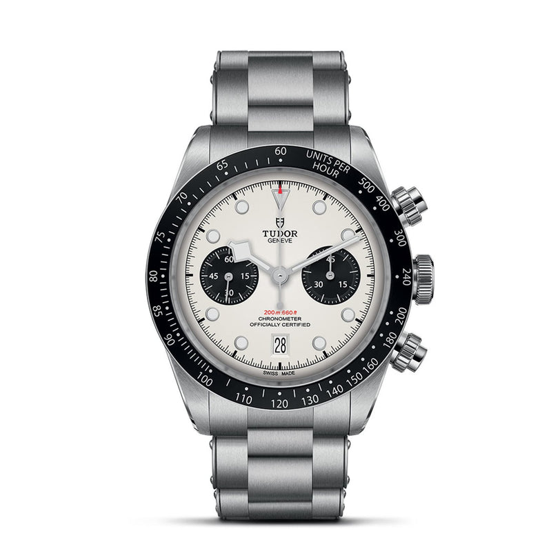 The TUDOR Black Bay Chrono is a stainless steel chronograph wristwatch with a white dial, black subdials, black bezel, date window at 6 o’clock, and a metal link bracelet.