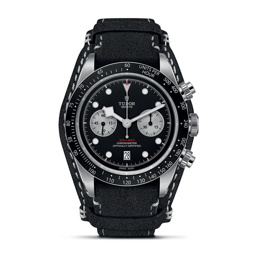 The TUDOR Black Bay Chrono features a leather strap, silver case, black dial with white subdials, tachymeter bezel, and a date display at 6 oclock—a striking modern chronograph.