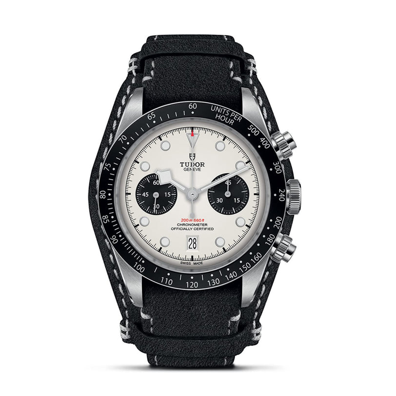 TUDOR’s Black Bay Chrono features a white dial with black subdials, a tachymetric bezel, black leather strap, and date display at 6 o’clock—an iconic chronograph design.