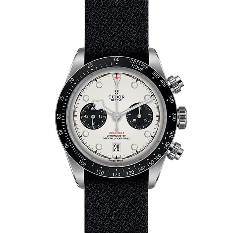 The TUDOR Black Bay Chrono features a black bezel, white dial with two black subdials, a black fabric strap, chronograph and date functions, plus a tachymetric scale for precise timekeeping.