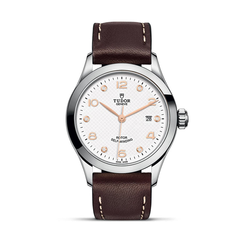 The TUDOR 1926 features a white textured dial, gold hour markers, date at 3 o’clock, and a brown leather strap—a classic, elegant wristwatch ideal for enthusiasts of refined mechanical timepieces.
