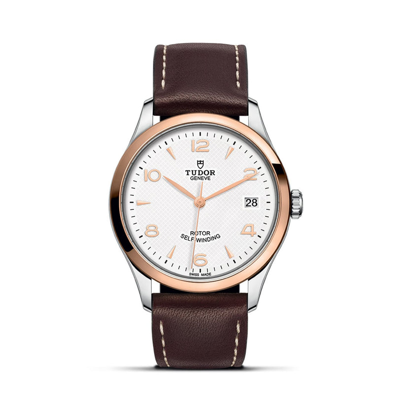 The TUDOR 1926 wristwatch features a brown leather strap, white dial, gold bezel, and date display at 3 oclock.
