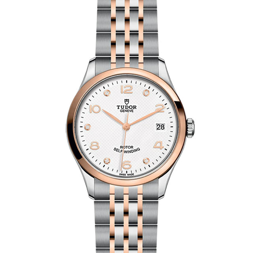 TUDOR 1926 wristwatch in silver and rose gold with white dial, date display, and metal bracelet.