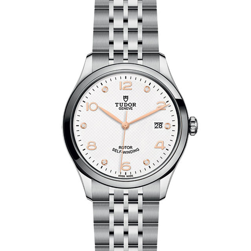 The TUDOR 1926 is a classic, elegant wristwatch with a silver metal bracelet, white textured dial, gold-tone indices and hands, and a date window at 3 o’clock—ideal for fans of finely crafted timepieces.