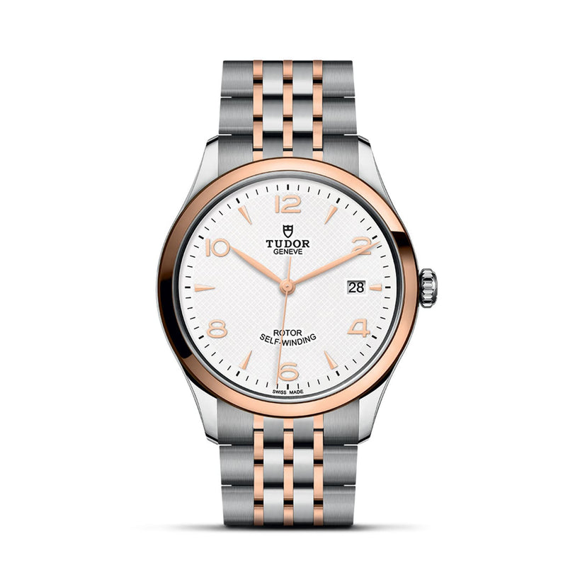 The TUDOR 1926 is a classic two-tone wristwatch featuring a white textured dial, date at 3 o’clock, and a silver and rose gold bracelet—a timeless choice for mechanical watch enthusiasts.