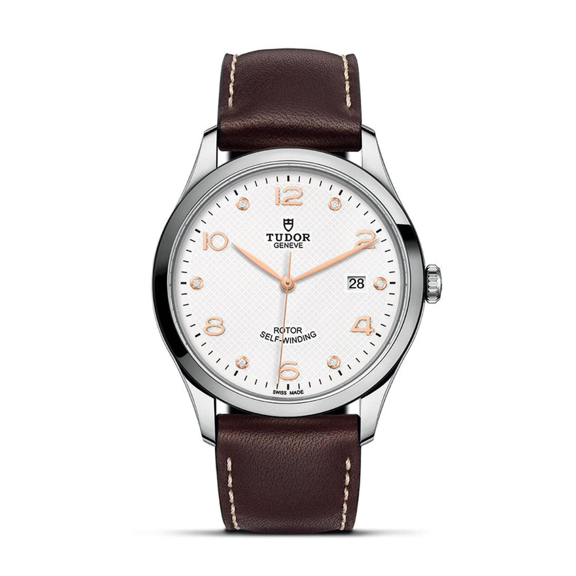 TUDOR 1926 wristwatch featuring a white dial, brown leather strap, silver case, and gold hour markers.