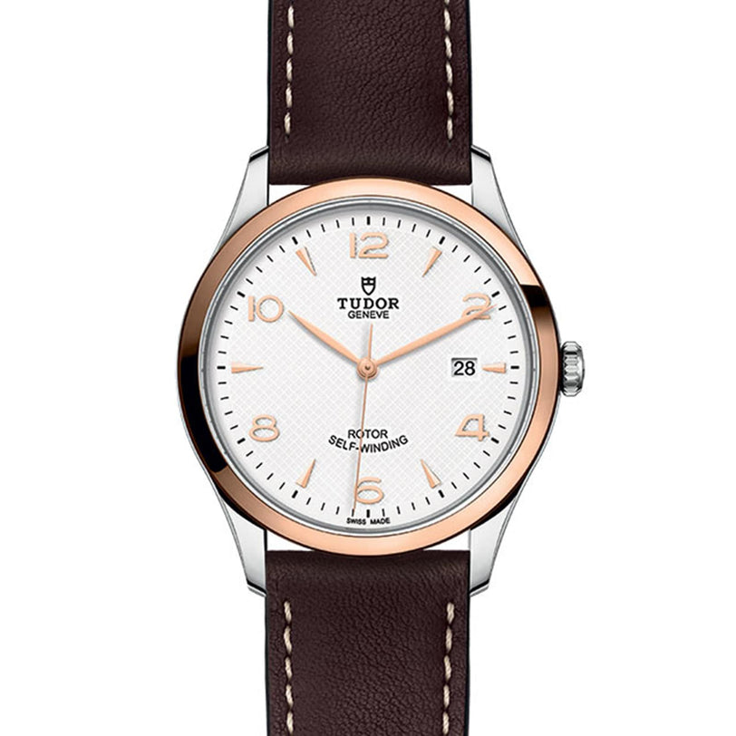 The TUDOR 1926 wristwatch features a brown leather strap, white dial, gold markers, and a date display at 3 oclock.