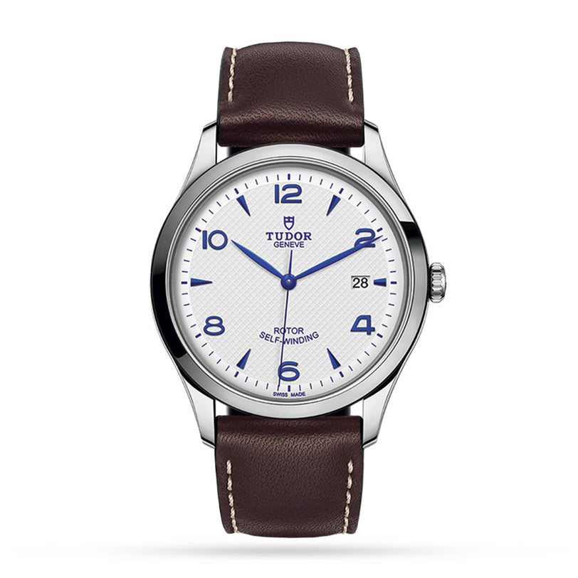 The TUDOR 1926 wristwatch pairs an opaline dial with blue Arabic numerals, a date at 3 o’clock, stainless steel case, and brown leather strap—classic style for mechanical watch enthusiasts.