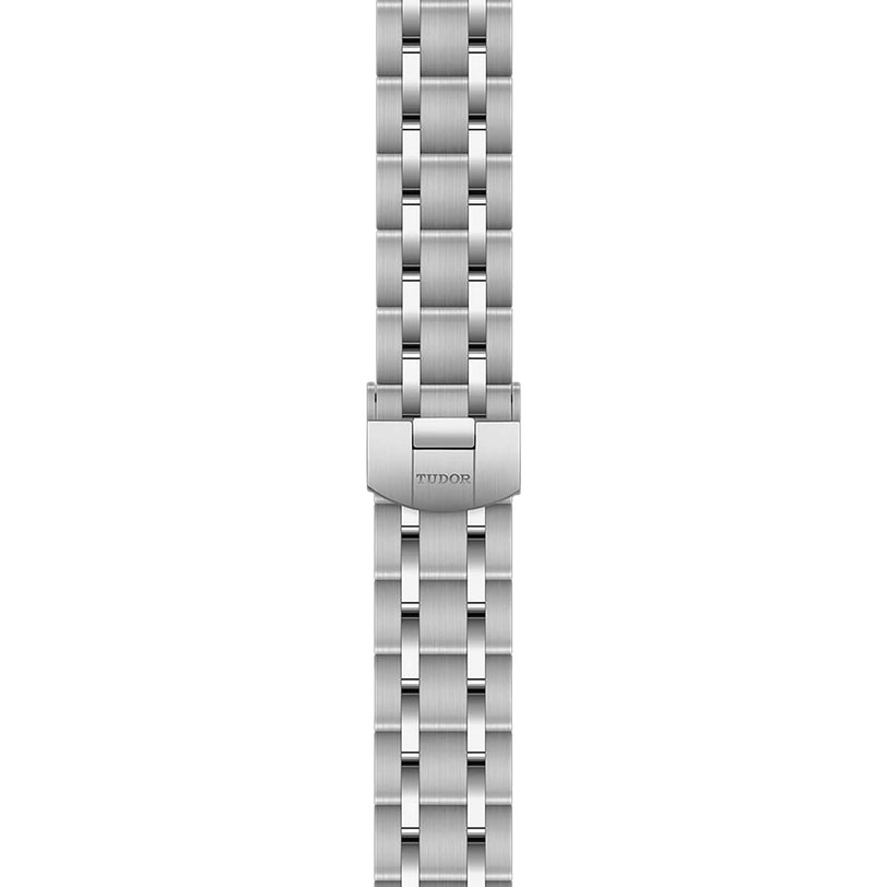 The TUDOR Royal watch features a stainless steel bracelet with a five-link design and branded clasp, displayed from a top-down perspective.