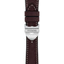 Close-up of a brown leather strap with white stitching, featuring a silver clasp engraved with TUDOR—a refined detail from the contemporary TUDOR 1926 watch collection.