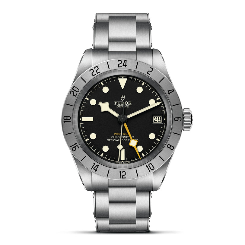 The TUDOR Black Bay Pro is a stainless steel wristwatch featuring a black dial, luminous markers, date at 3 o’clock, 24-hour bezel, and matching metal bracelet—a modern tribute to TUDOR divers’ watches.