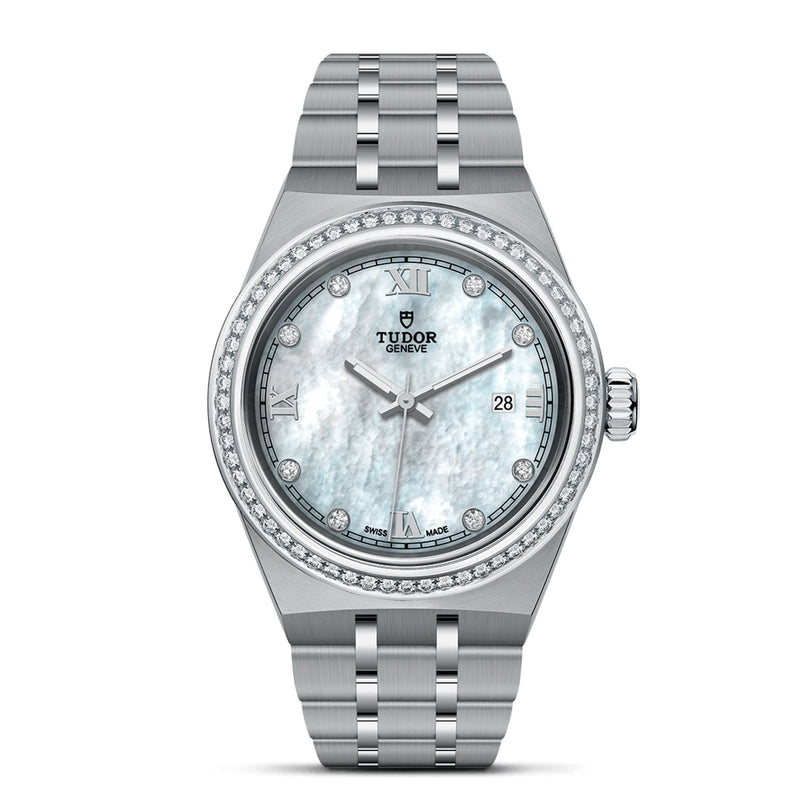 The TUDOR Royal is a silver wristwatch with a stainless steel band, diamond-set bezel, mother-of-pearl dial, Roman numerals, and a date window at 3 o’clock.