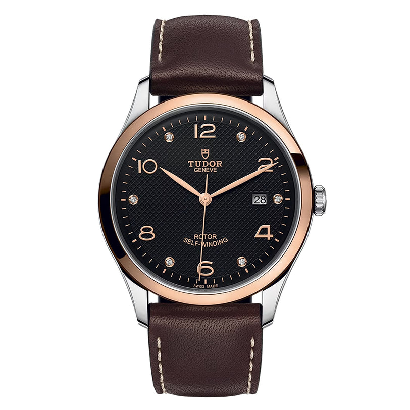 The TUDOR 1926 is a contemporary wristwatch with a brown leather strap, black dial, gold-tone bezel, silver and gold hour markers, and a date display at 3 o’clock—an elegant pick for fans of mechanical timepieces.