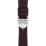 Close-up of a brown leather watch strap with white stitching, featuring a silver clasp engraved with TUDOR—an elegant detail of the TUDOR 1926 collection.