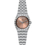 The TUDOR Royal is a stainless steel wristwatch with a pink dial, day and date display, diamond hour markers, and a sport-chic metal link bracelet.