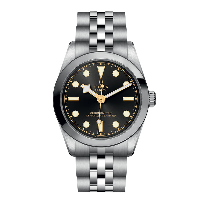 The image shows a TUDOR Black Bay 31 wristwatch in stainless steel with a black dial, silver hour markers, and a metal link bracelet, set to 10:10—showcasing its unisex style and refined Manufacture Calibres craftsmanship.