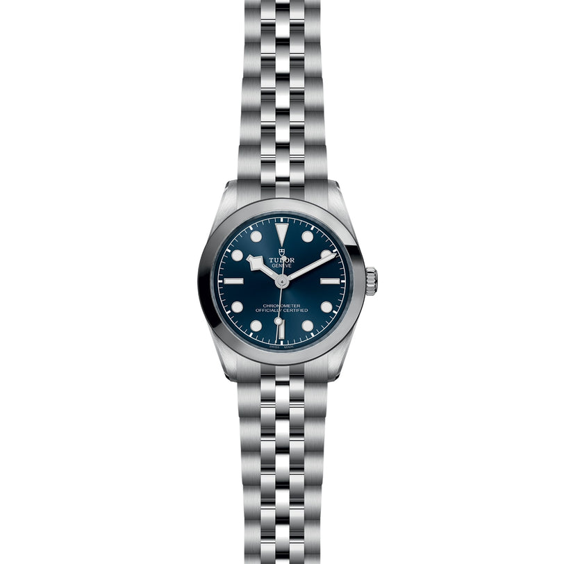 The TUDOR Black Bay One 31 is a silver unisex wristwatch with a blue dial, white hour markers, and a five-link stainless steel bracelet—an elegant timepiece inspired by Black Bay models, displayed on a white background.