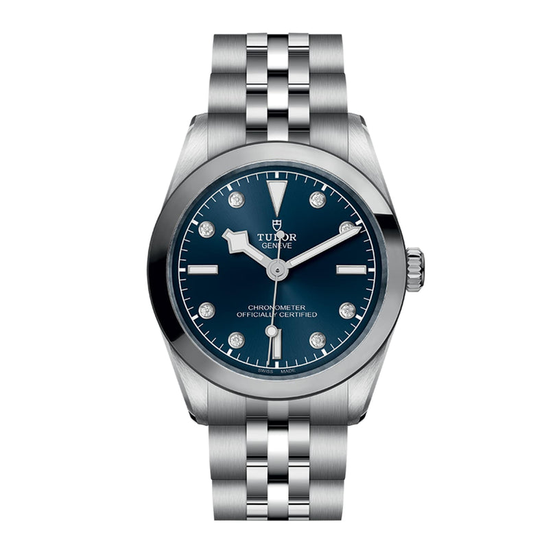 The TUDOR Black Bay One 31 is a stainless steel wristwatch with a blue dial, diamond hour markers, silver hands, and a metal bracelet. Inspired by Black Bay models, it offers unisex style and precise Manufacture Calibres.