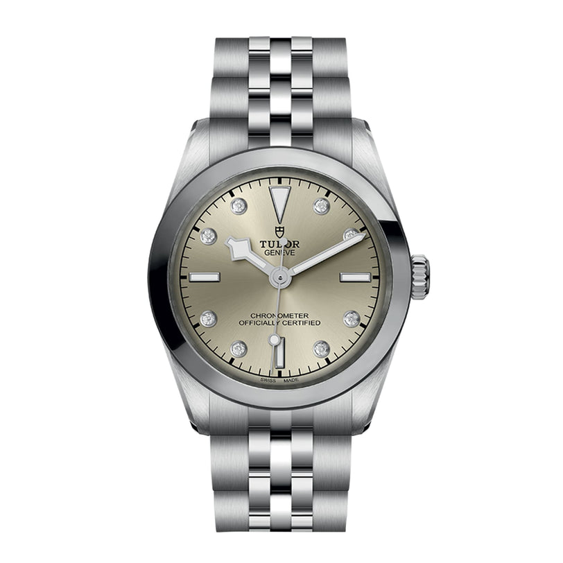 The TUDOR Black Bay One 31 is a unisex stainless steel watch with a champagne dial, diamond hour markers, a metal link bracelet, and refined technical features inspired by Black Bay models.