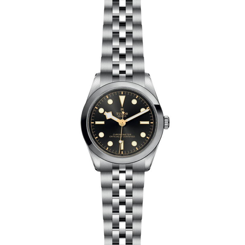 The TUDOR Black Bay One 36 is a stainless steel unisex wristwatch featuring a black dial, vintage hour markers, and a metal bracelet—a chic expression of technical refinement.