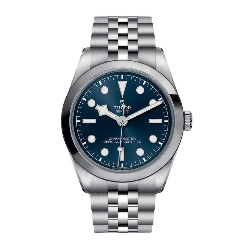 The TUDOR Black Bay One 36 is a stainless steel unisex wristwatch with a blue dial, silver hour markers, and a five-link bracelet—chic style powered by Manufacture Calibres and shown against a white background.
