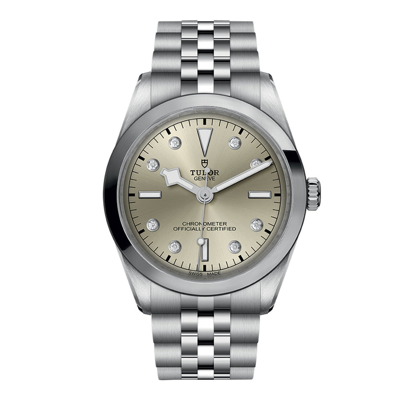 The TUDOR Black Bay One 36 is a stainless steel wristwatch with a champagne dial, diamond hour markers, date at 3 o’clock, and a durable 316L steel bracelet inspired by Black Bay designs.