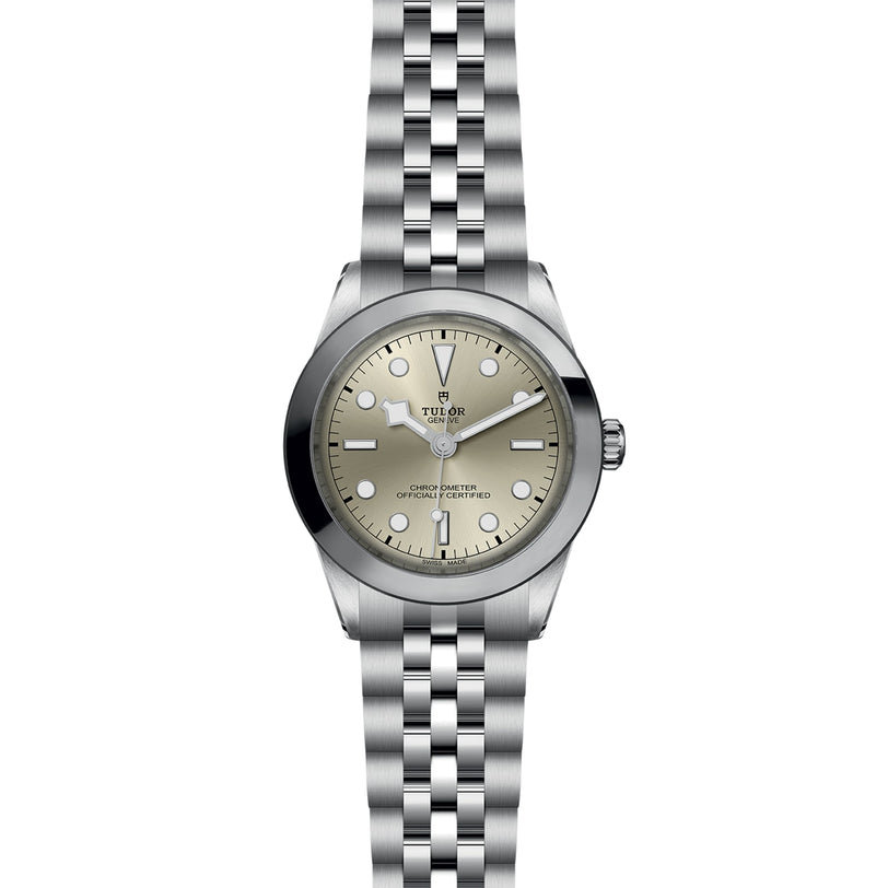 TUDOR Black Bay One 39 wristwatch featuring a round beige dial, metal bracelet, and simple hour markers.