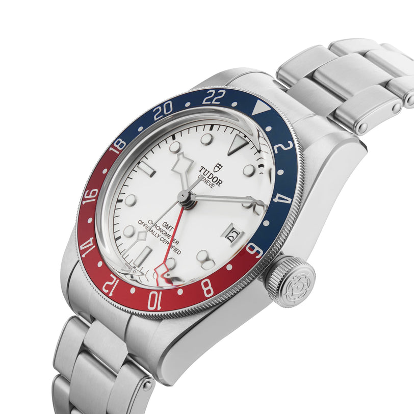 The TUDOR Black Bay GMT features a stainless steel case, opaline dial, red and blue GMT bezel, silver bracelet, and a date display at 3 o’clock.