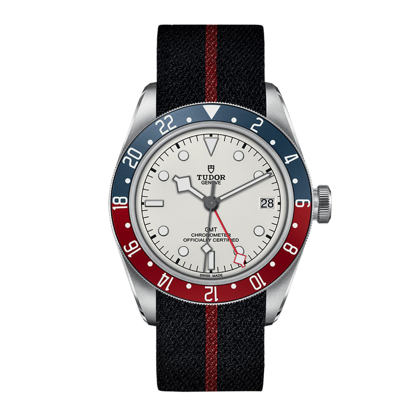 The TUDOR Black Bay GMT features an opaline dial, blue and red bezel, black strap with red stripe, and date display at 3 o’clock—ideal for stylishly tracking multiple time zones.