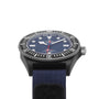 A close-up of the TUDOR Pelagos FXD, featuring a blue dial in a black case with a blue fabric strap—engineered for waterproof performance and precise underwater navigation.