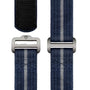 Three blue fabric straps with light gray center stripes and silver-tone buckles, designed for the TUDOR Pelagos FXD, are displayed against a white background.