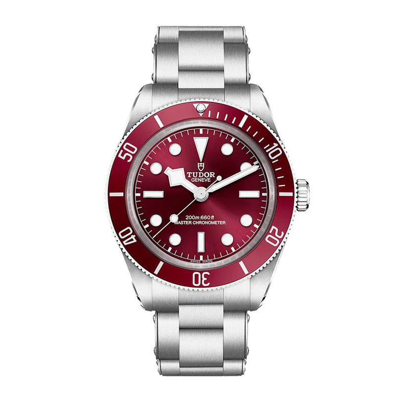 A TUDOR Black Bay 58 dive watch with a red bezel, red dial, and silver stainless steel bracelet, displayed face up.
