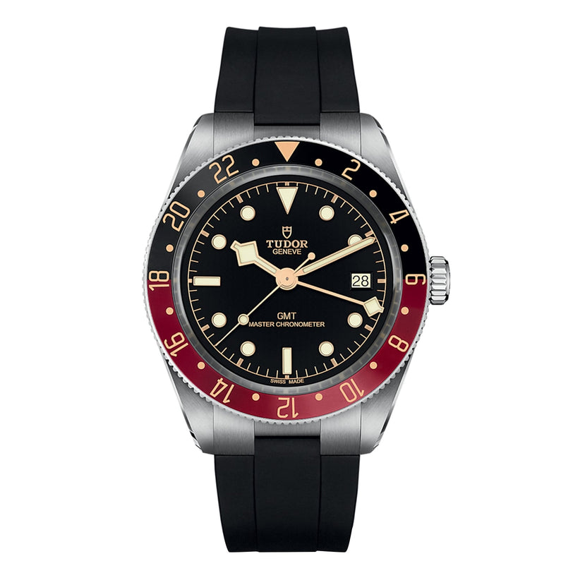 The TUDOR Black Bay 58 GMT dive watch features a black dial, red and blue bezel, date window at 3 o’clock, and a sleek black rubber strap.