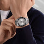 A person wearing a TUDOR Black Bay 68 dive watch with a black bezel and metal strap on their left wrist.