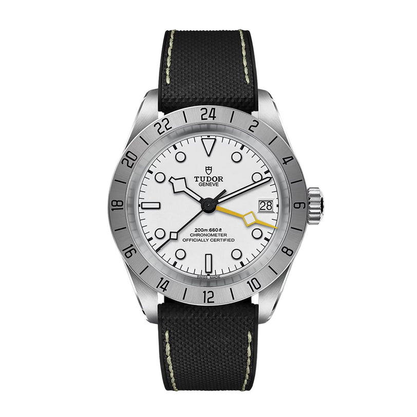 The TUDOR Black Bay Pro is a wristwatch featuring a white dial, black strap, date display, and a silver bezel with 24-hour numerals.