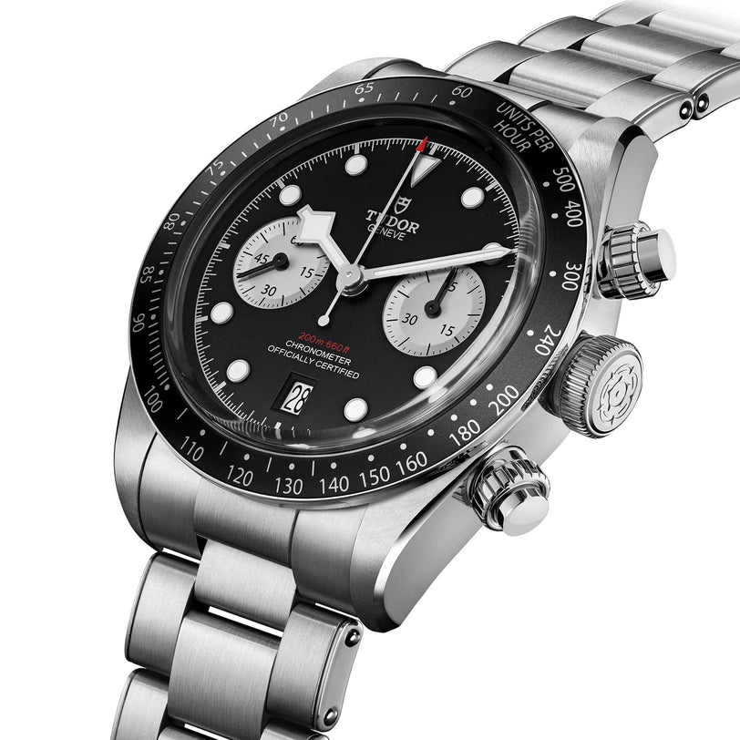 A TUDOR Black Bay Chrono stainless steel watch with a black dial and silver bracelet, displayed at an angle.