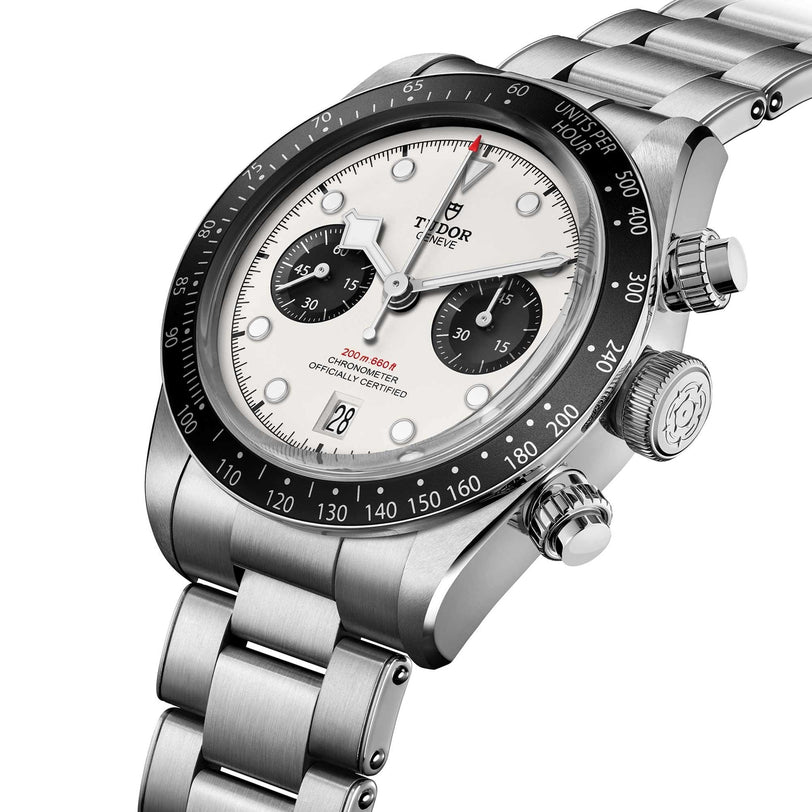 The TUDOR Black Bay Chrono is a stainless steel chronograph watch featuring black subdials, a white dial, and a metal bracelet.
