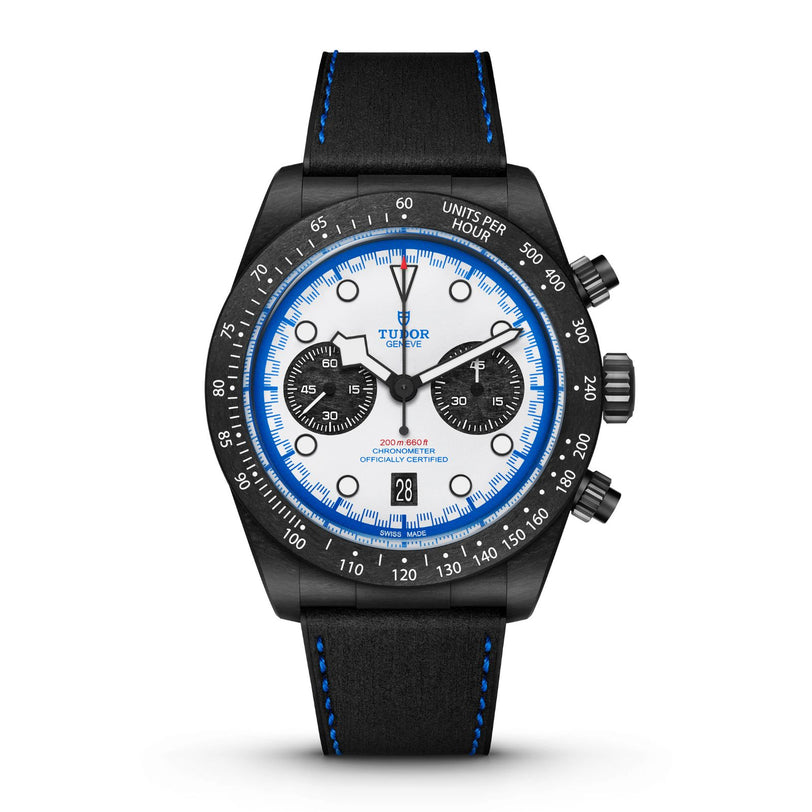 The TUDOR Black Bay Chrono is a black and white wristwatch with blue accents, a chronograph dial, and a black leather strap.