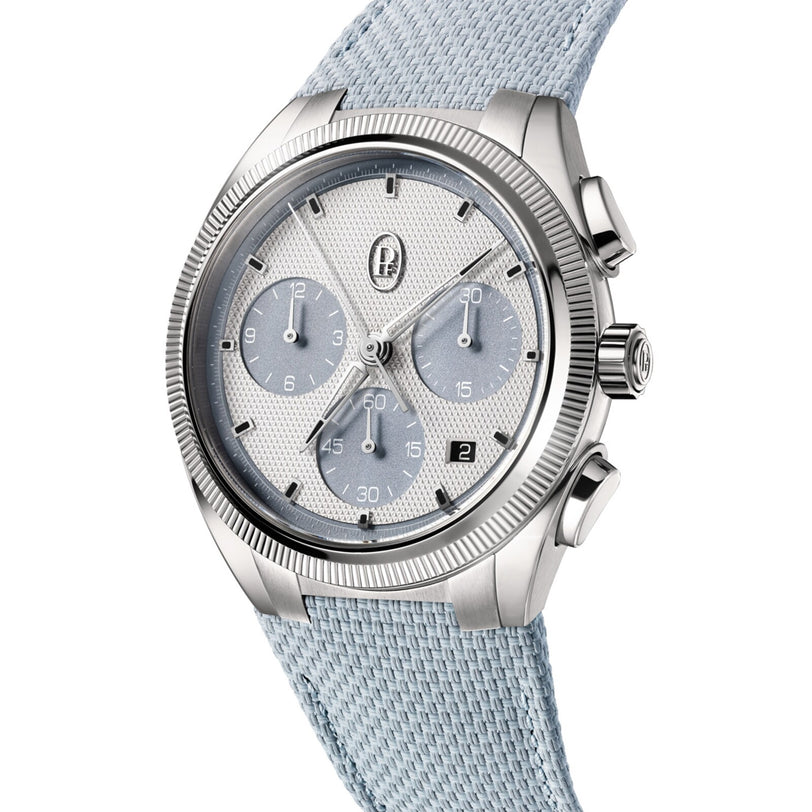 The Parmigiani Fleurier TONDA PF Sport Chronograph features a textured dial and light blue fabric strap, shown angled for display.